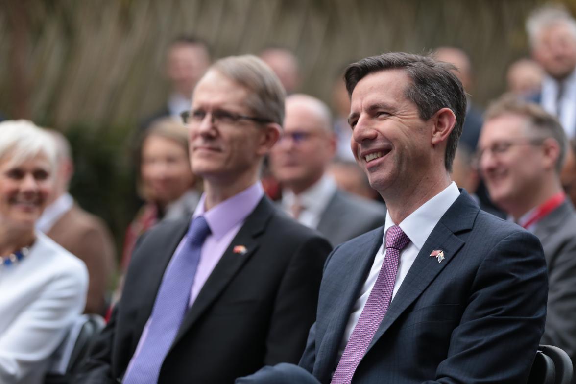 Trade, Tourism and Investment Minister Simon Birmingham and Australian Ambassador to China Graham Fletcher sitting in a crowd.