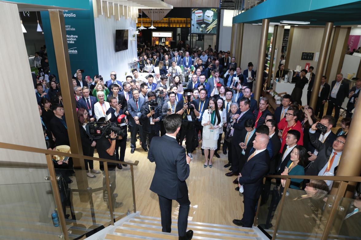 Trade, Tourism and Investment Minister Simon Birmingham standing on a staircase addressing a crowd.