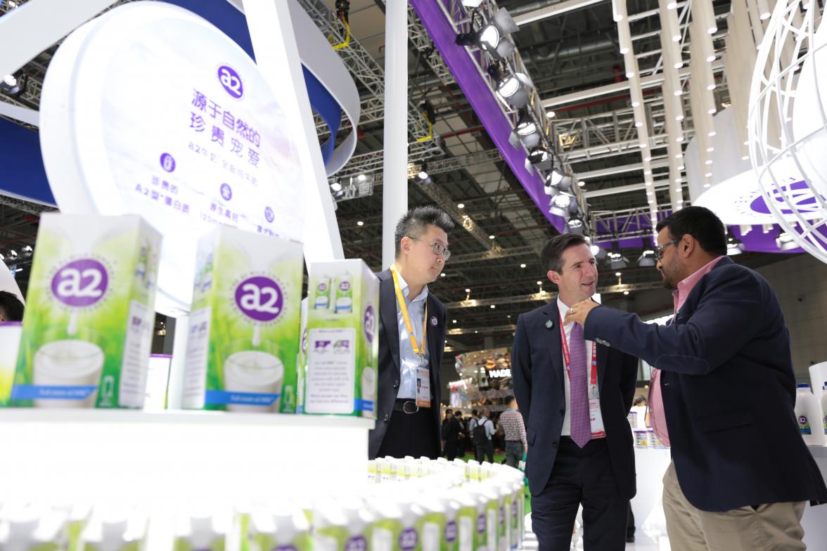 Trade, Tourism and Investment Minister Simon Birmingham looking at the a2 Milk Company pavilion.