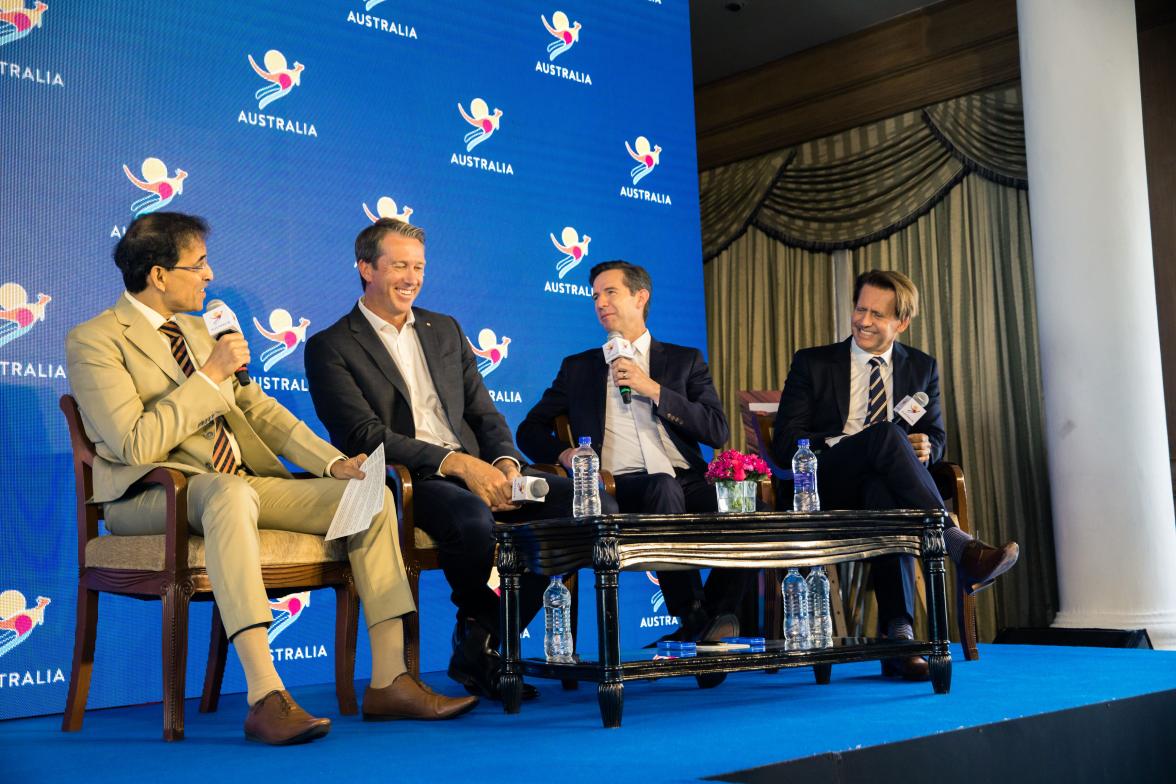 Group photo of Minister Simon Birmingham speaking on stage with cricket commentator Harsha Bhogle, Glenn McGrath and Tourism Australia Board Chairman Bob East.