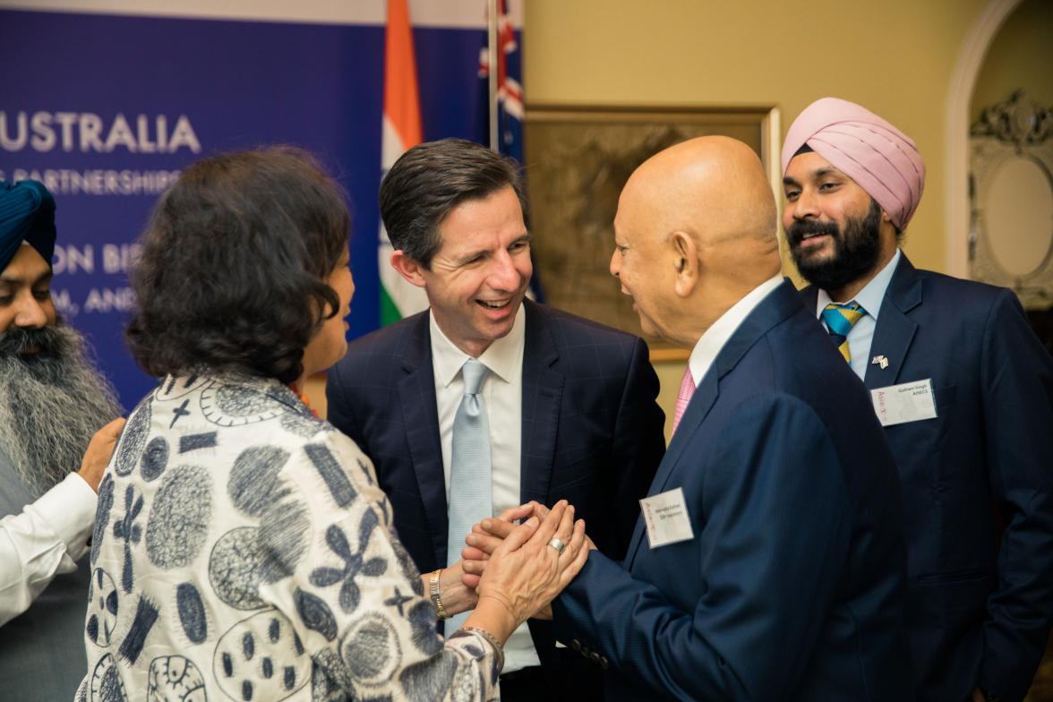 Photo of Minister Simon Birmingham shaking hands with members of the Asia Society