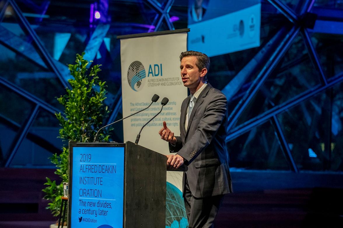 Photo of Minister Birmingham on stage delivering a speech at the 2019 Alfred Deakin Institute Oration.