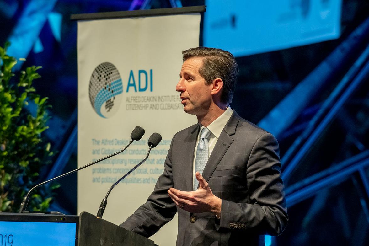 Photo of Minister Birmingham on stage delivering a speech at the 2019 Alfred Deakin Institute Oration.