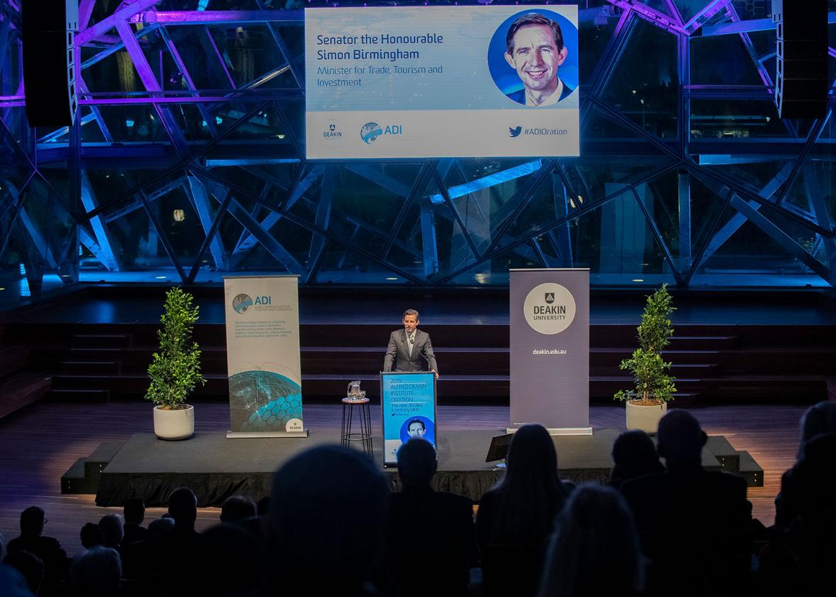 Photo of Minister Birmingham on stage delivering a speech at the 2019 Alfred Deakin Institute Oration.