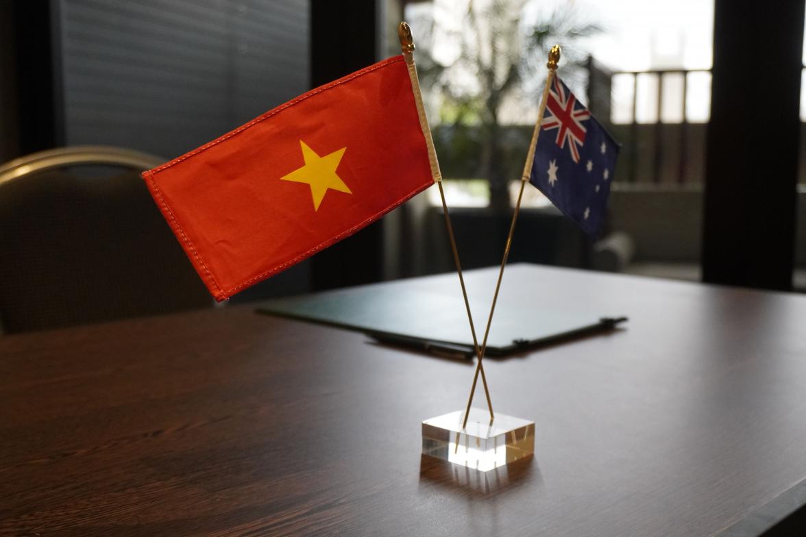 Photo of Vietnamese and Australian flags on a table. 