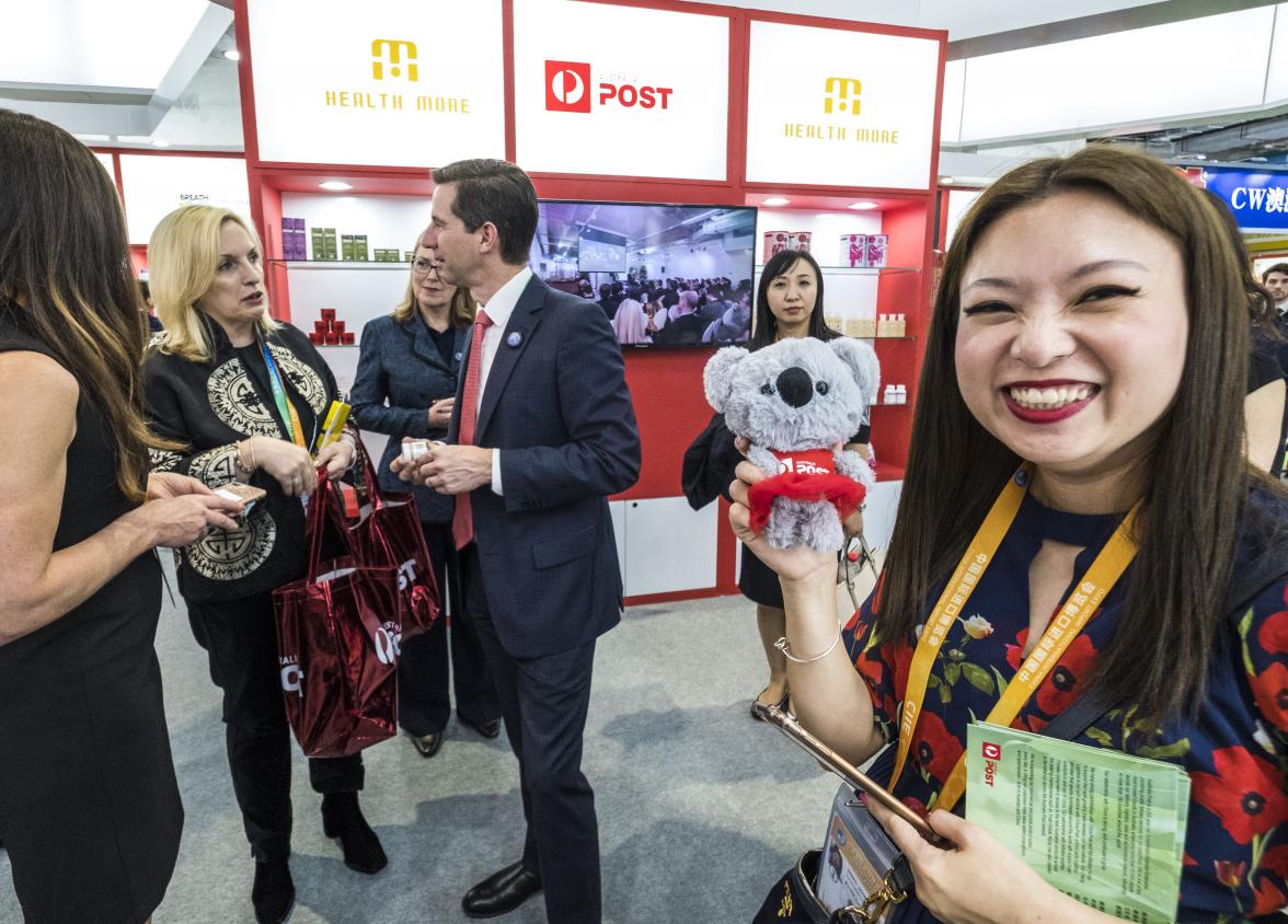 Federal Minister for Trade, Tourism & Investment Simon Birmingham talking with Australia Post CEO Christine Holgate while Sheryl Soon holds an Australia  Post Koala on day one of the China International Import Expo in Shanghai, which was officially opened