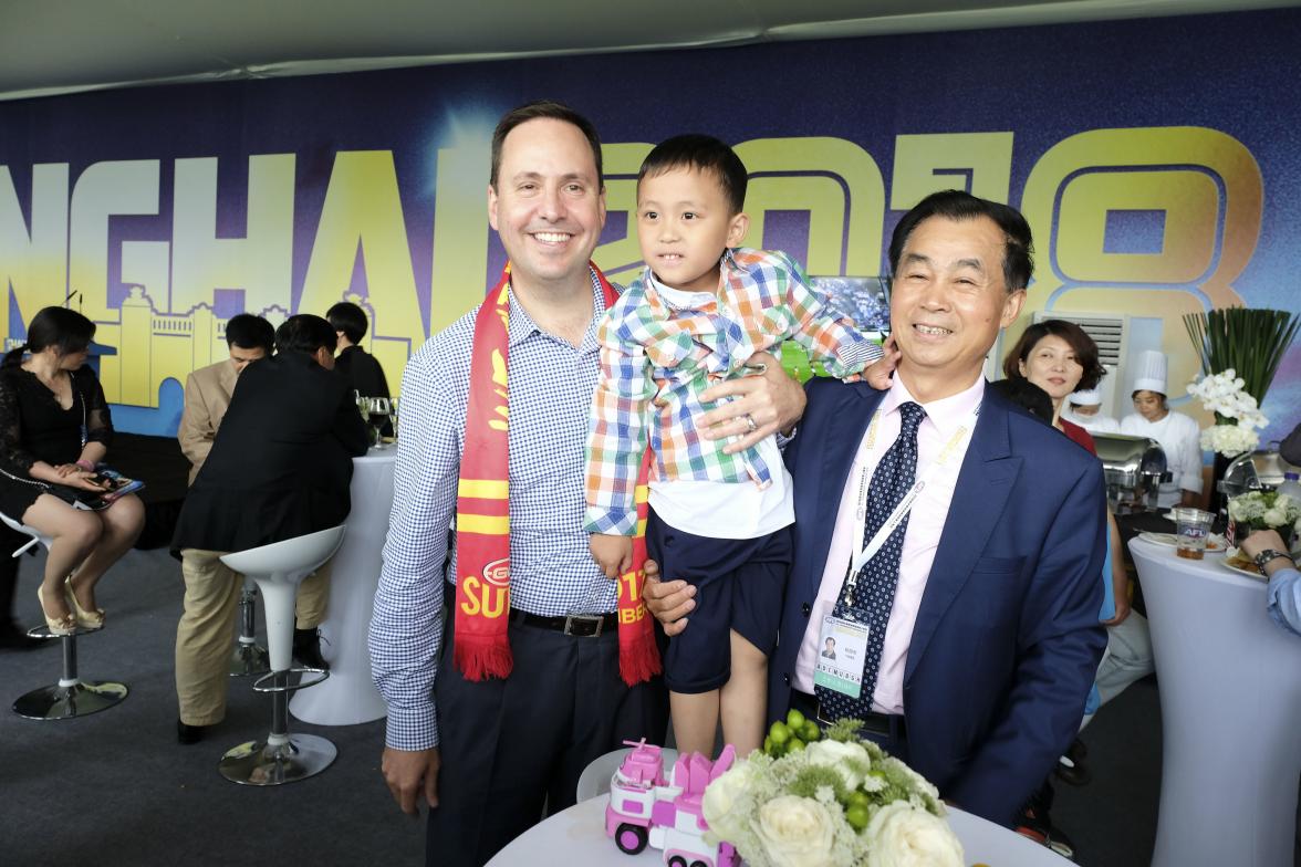 Federal Minister for Trade, Tourism & Investment Steven Ciobo at the AFL match in Shanghai with Shanghai CRED President Gui Guojie & grandson Gui Haoteng     Photo credit: DFAT/Chris Crerar(c)DFAT Australia / High res filename reference: 6758