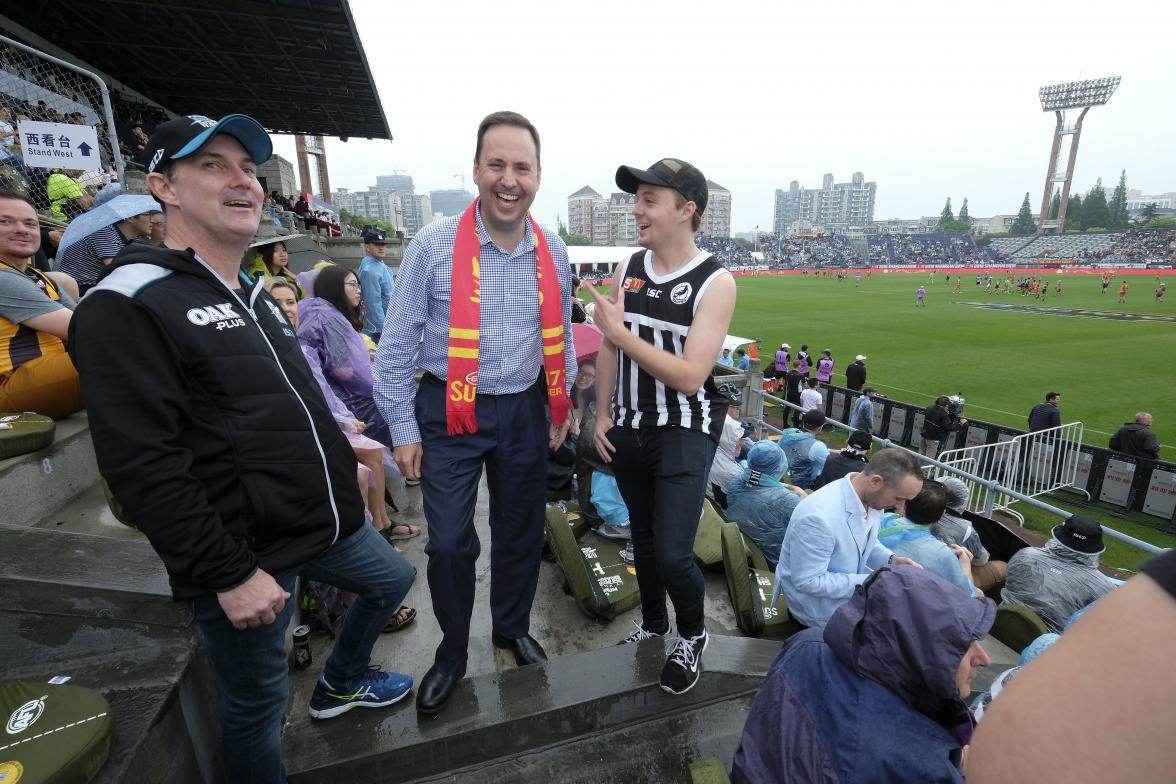 Federal Minister for Trade, Tourism & Investment Steven Ciobo at the AFL match in Shanghai with Port Adelaide fans (L) Robert Blackborough and Senna Blackborough      Photo credit: DFAT/Chris Crerar(c)DFAT Australia / High res filename reference: 7135