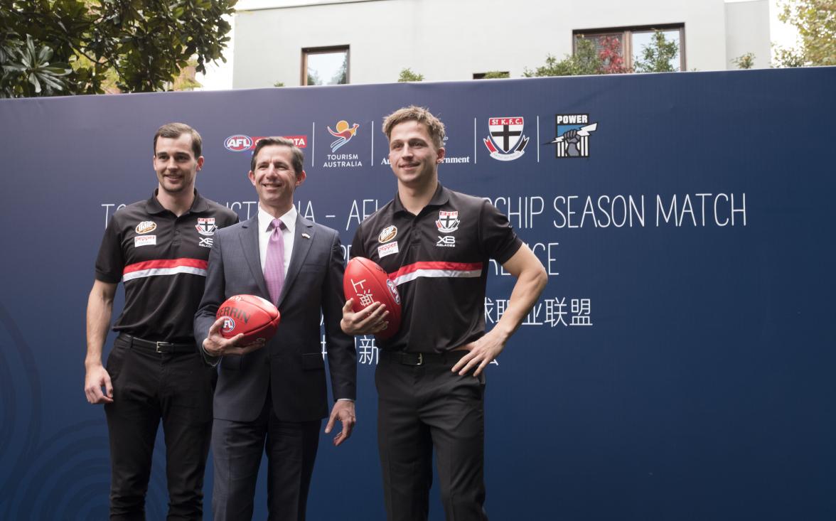 Federal Minister for Trade, Tourism & Investment Simon Birmingham talks with St Kilda players Jack Billiangs and Daniel McKenzie (L)  in Shanghai at the Australian Consulate after an AFL China press call . Photo credit: DFaT/Chris CrerarHigh res filenam