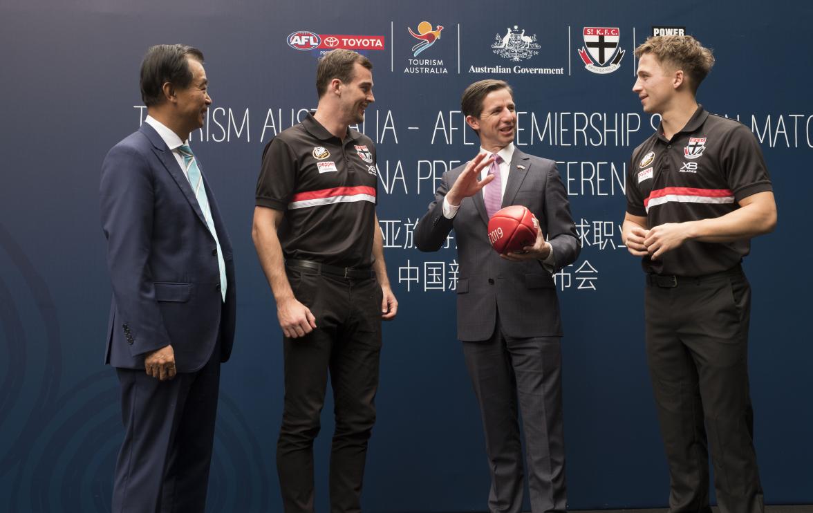 Federal Minister for Trade, Tourism & Investment Simon Birmingham talks with St Kilda players Jack Billiangs and Daniel McKenzie (L) with Shanghai Cred Chairman Gui Guojie   in Shanghai at the Australian Consulate after an AFL China press call . Photo cre