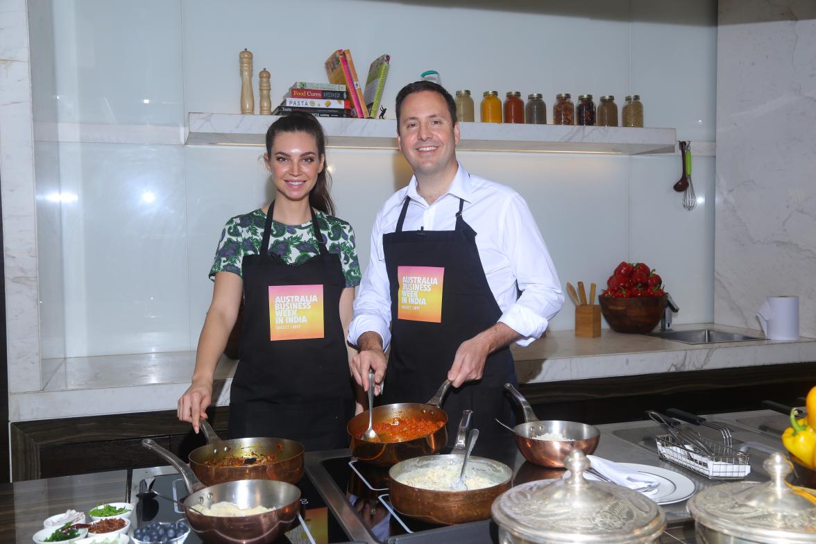 Minister for Trade, Tourism and Investment, the Hon Steven Ciobo MP, receiving a cooking lesson from former Masterchef contestant Sarah Todd