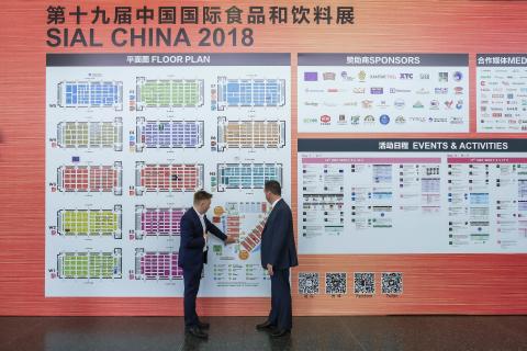 Federal Minister for Trade, Tourism & Investment Steven Ciobo at the Shanghai SIAL Food Industry Expo is shown the locations of Australian exhibitors by AusTrade's Brent Moore.                                      Photo credit: DFaT/Chris Crerar(c)DFaT 